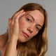 Lady applying Acnefekt Gel on face
